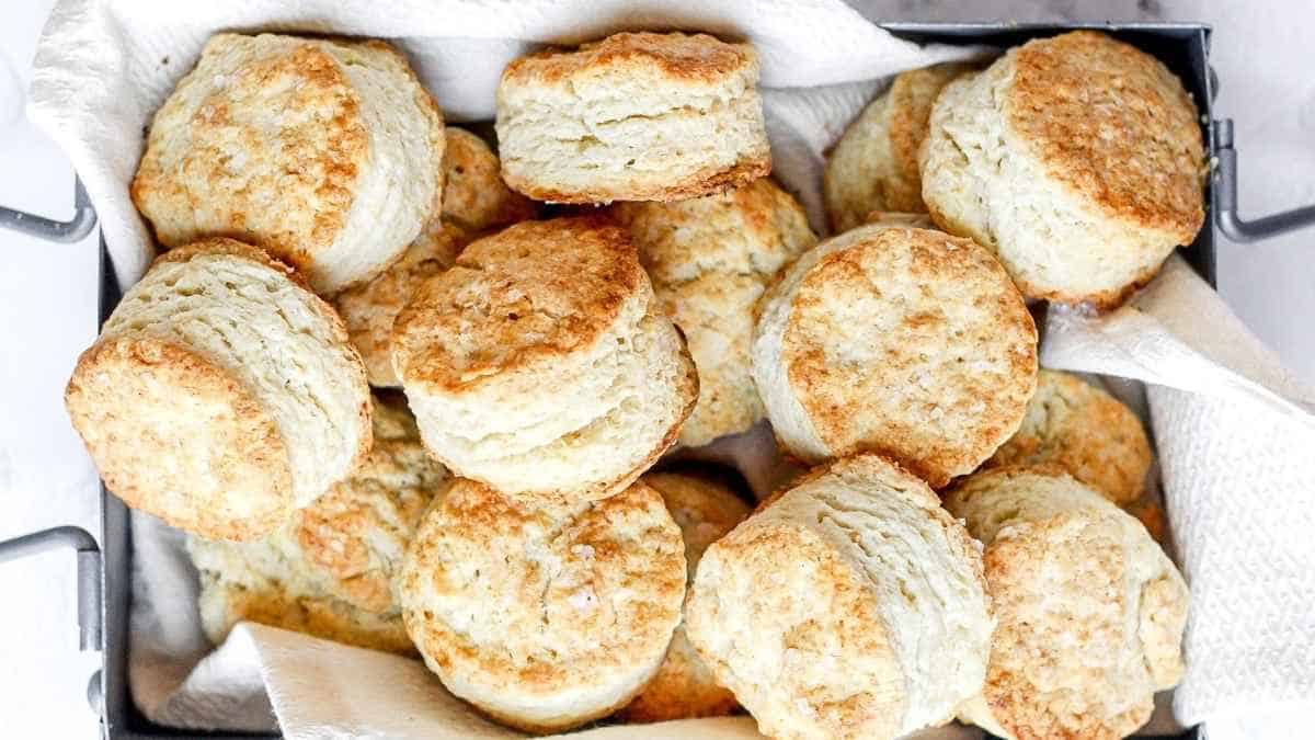 A tray full of biscuits on a white table.