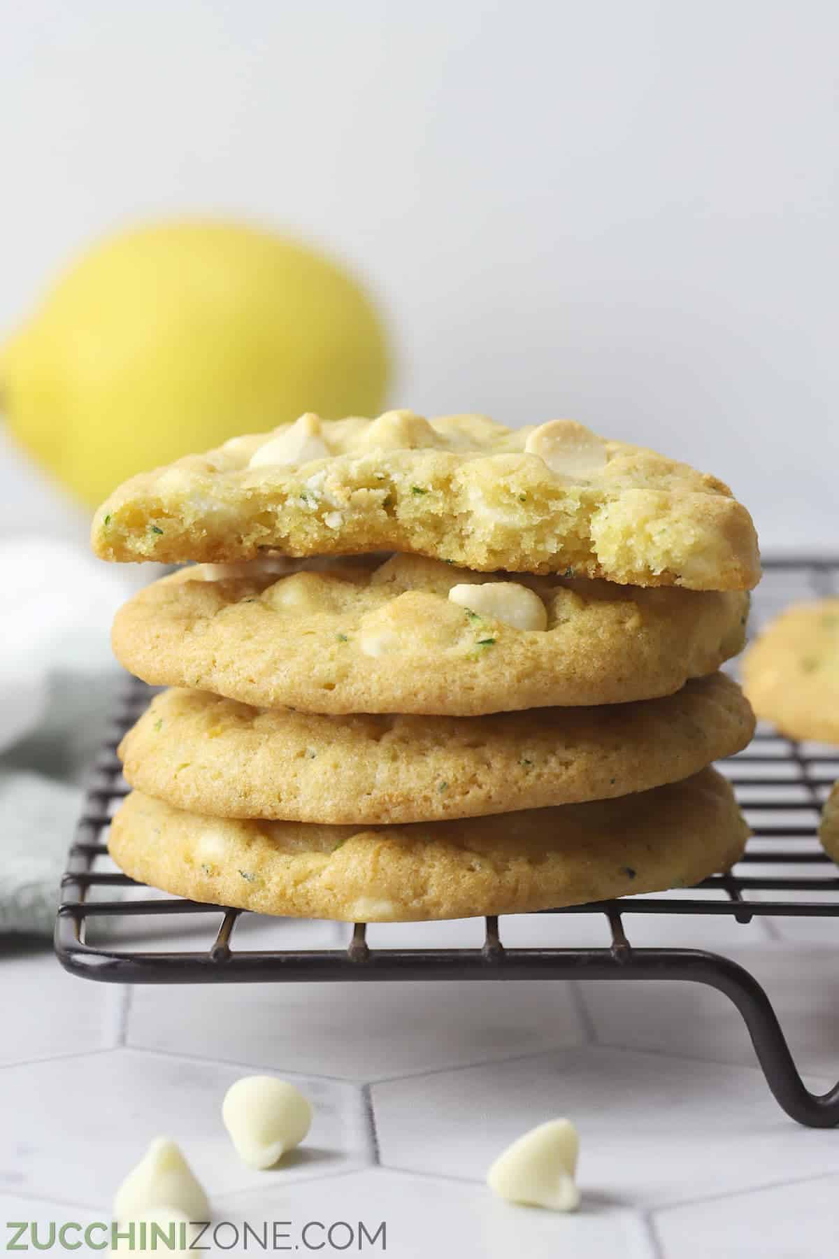 A stack of lemon cookies, made from a unique cookie recipe, on a cooling rack.