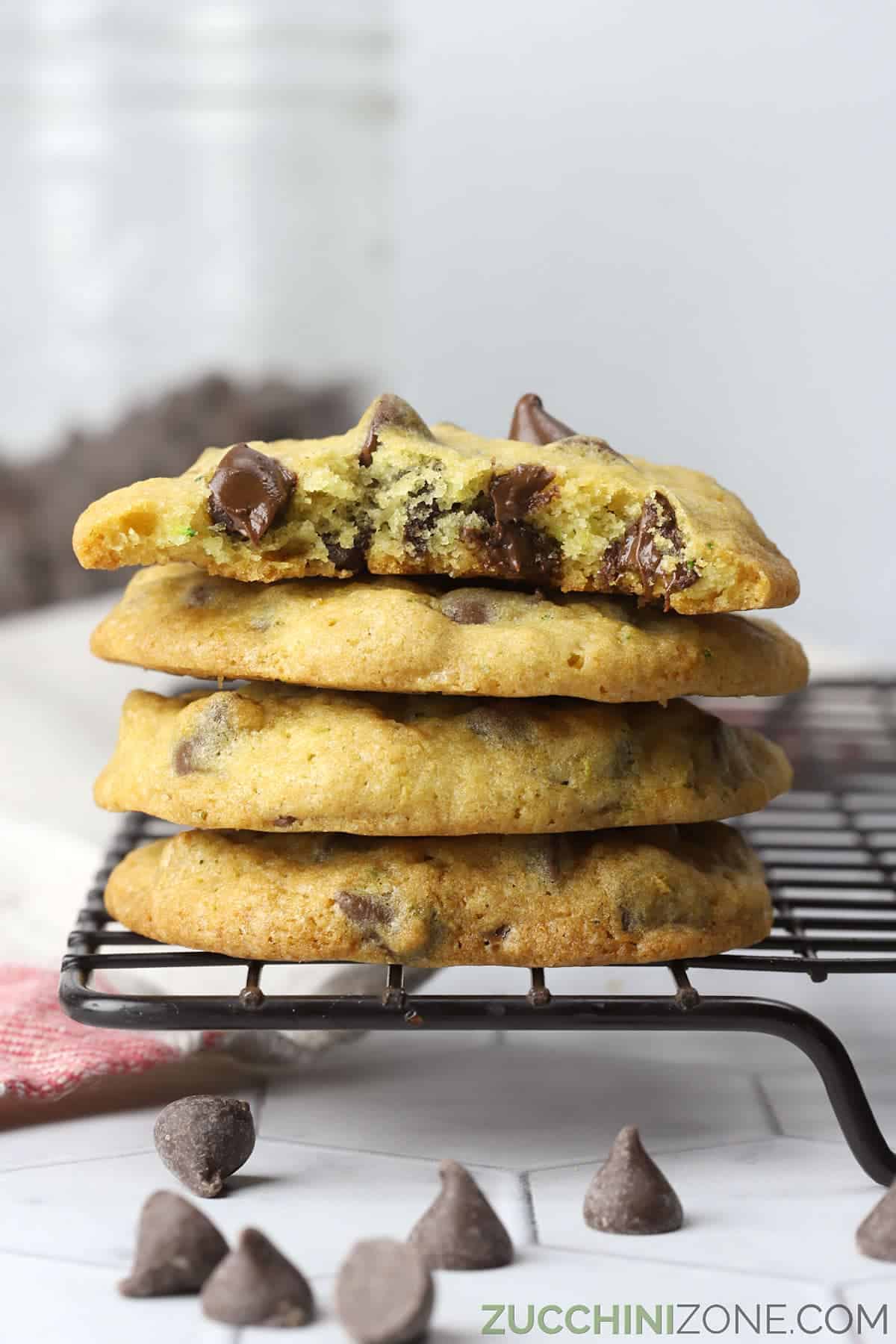 A stack of unique chocolate chip cookies on a cooling rack.