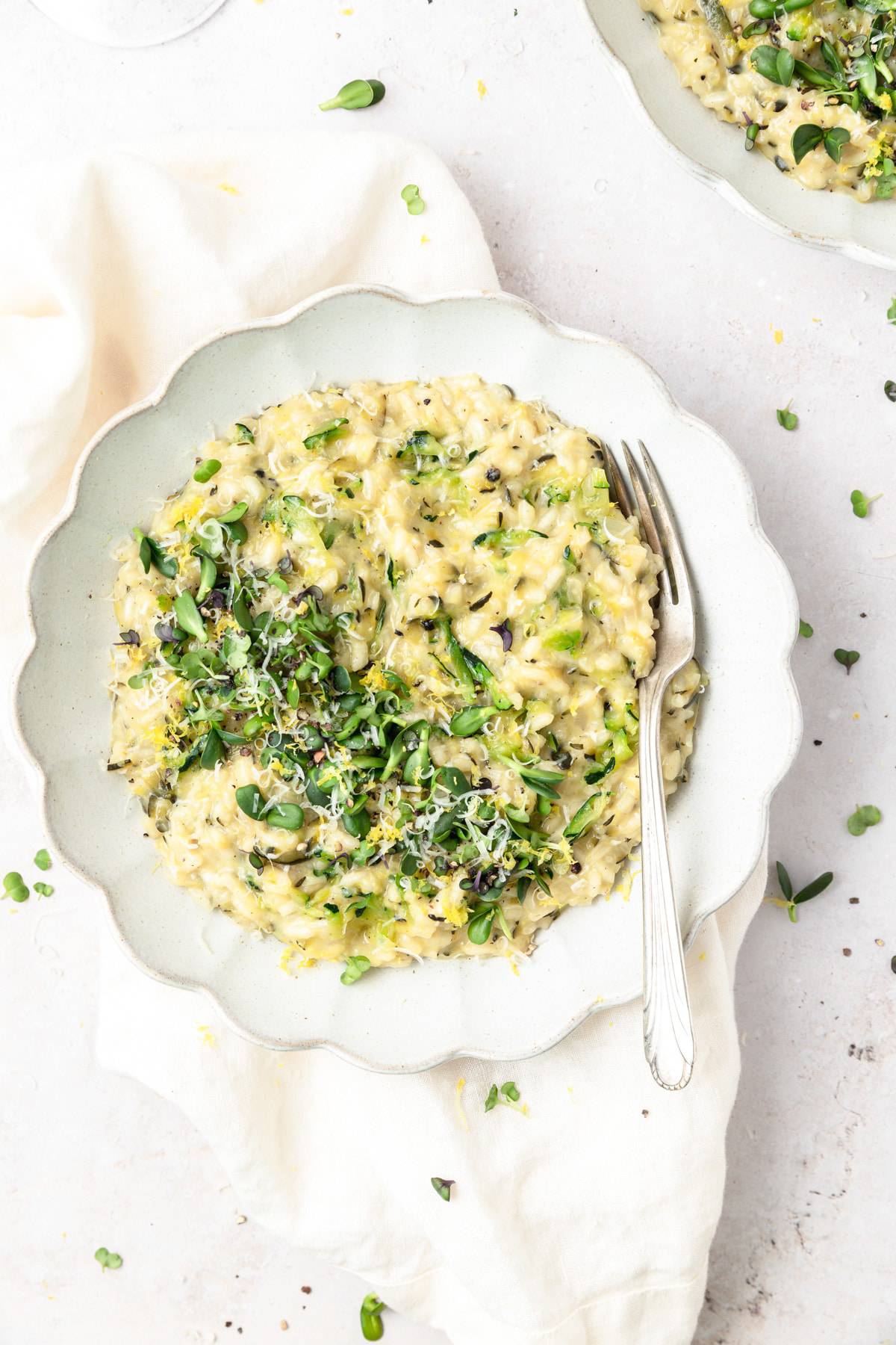 bowl of creamy zucchini risotto with microgreens. 
