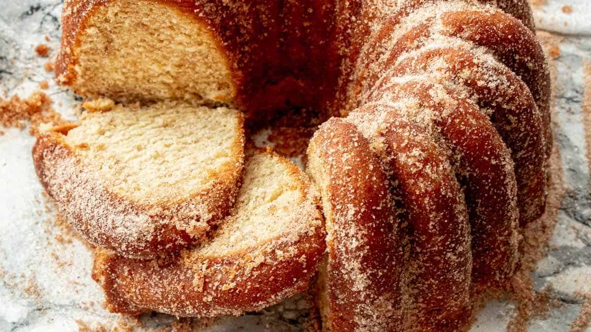 Sliced cinnamon sugar bundt cake on a surface.