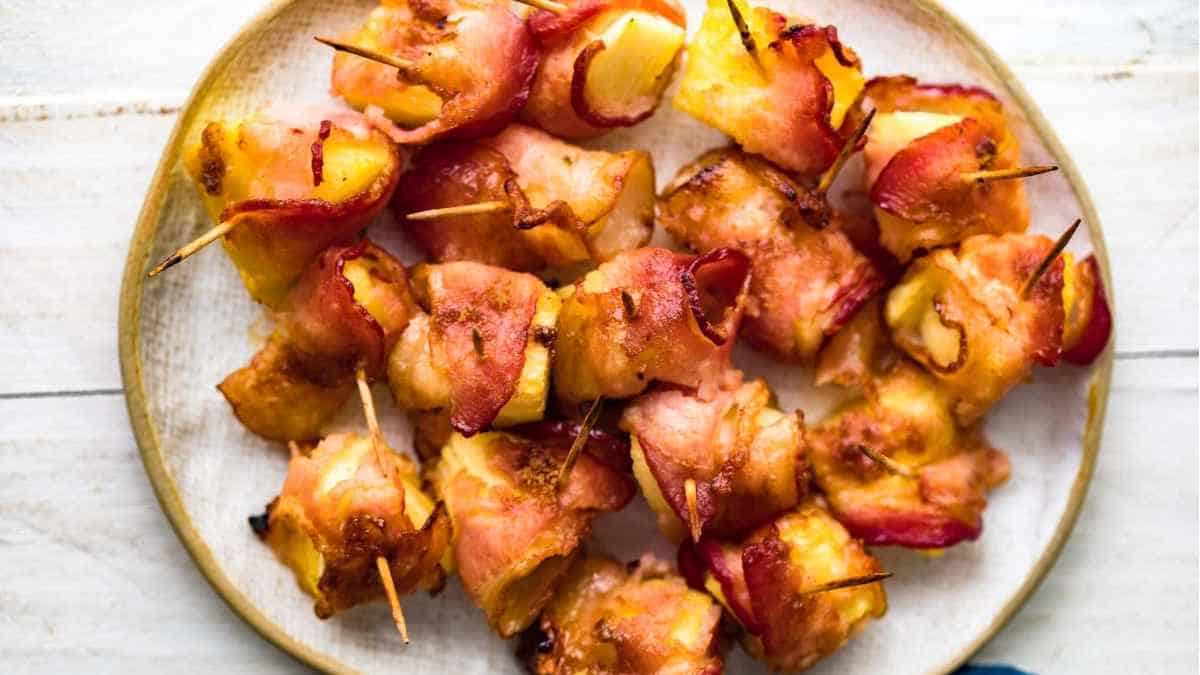 Bacon wrapped skewers on a plate.