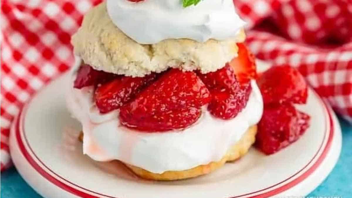 Strawberry shortcake topped with whipped cream and strawberries.