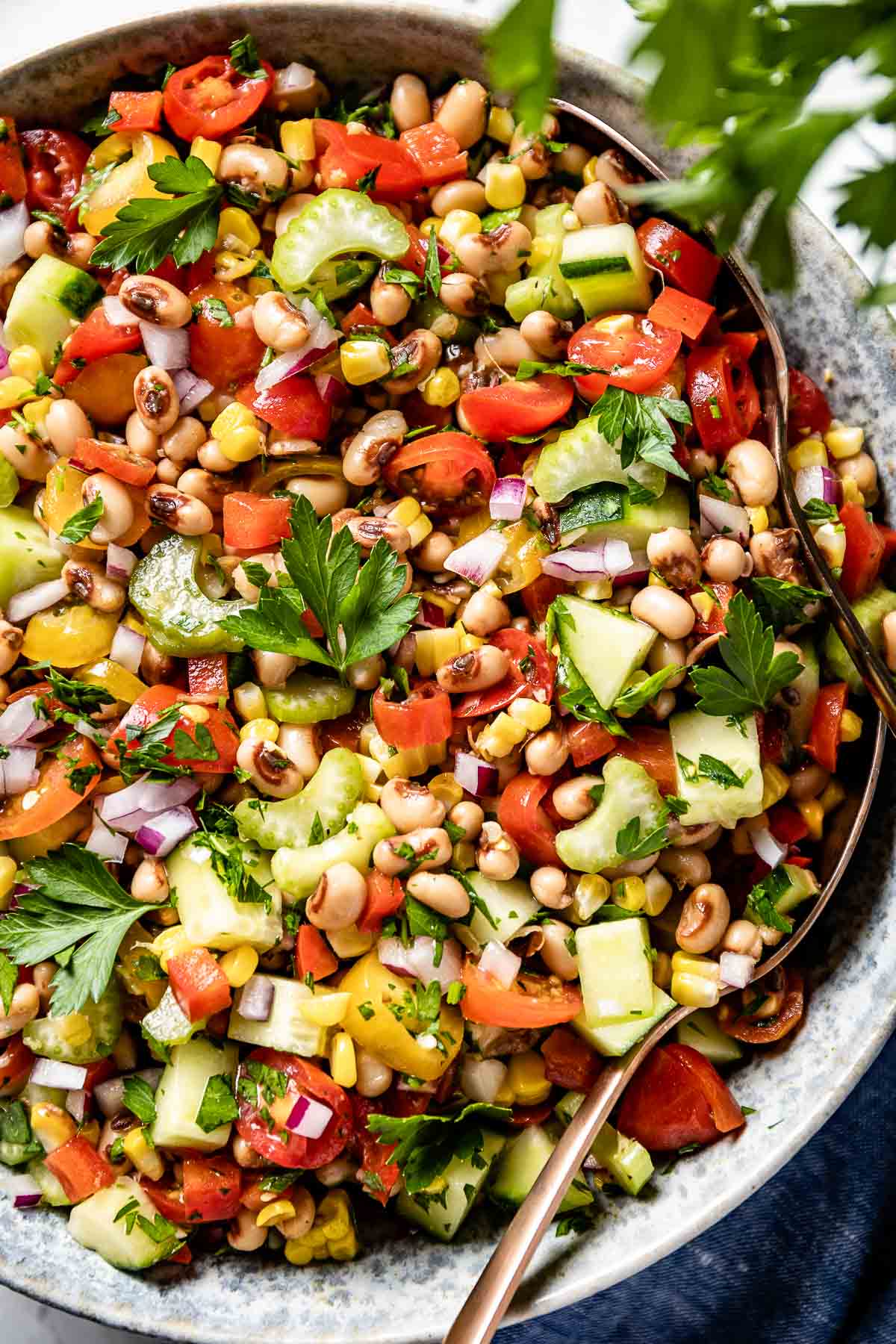 Blackeyed peas salad in a bowl with spoon on the side.
