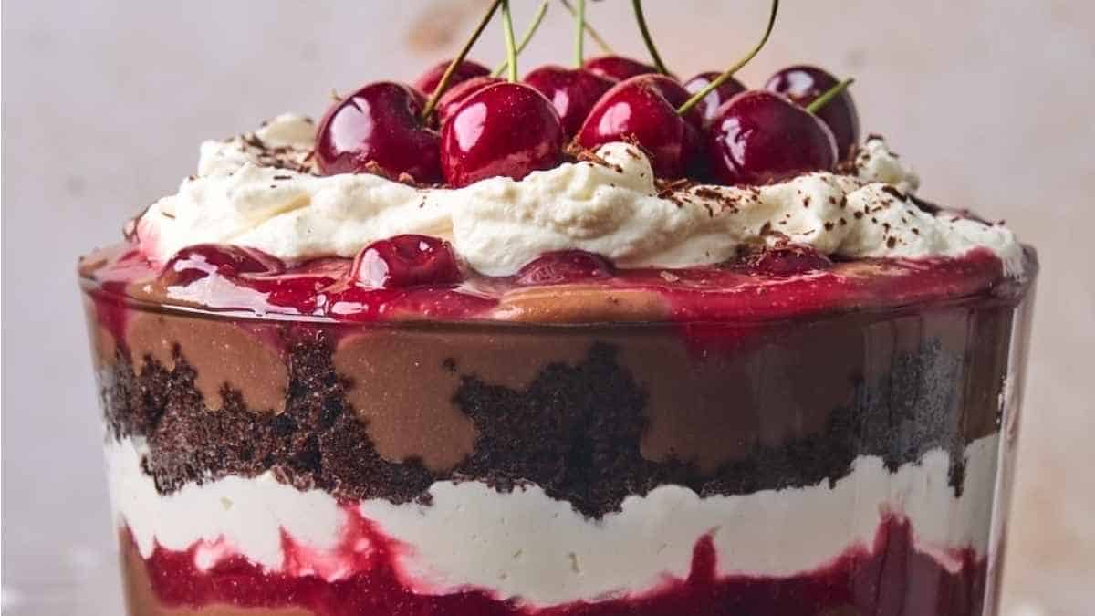 A trifle with chocolate, cherries and whipped cream.