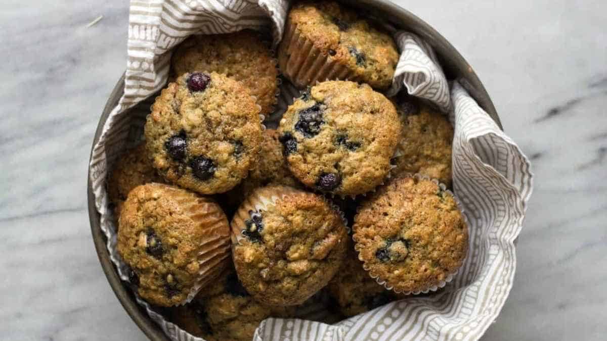 A bowl of muffins with blueberries in them.