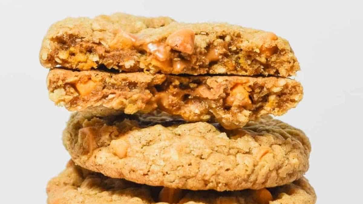 A stack of peanut butter cookies with a bite taken out of them.