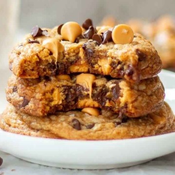 A stack of chocolate peanut butter cookies on a white plate.