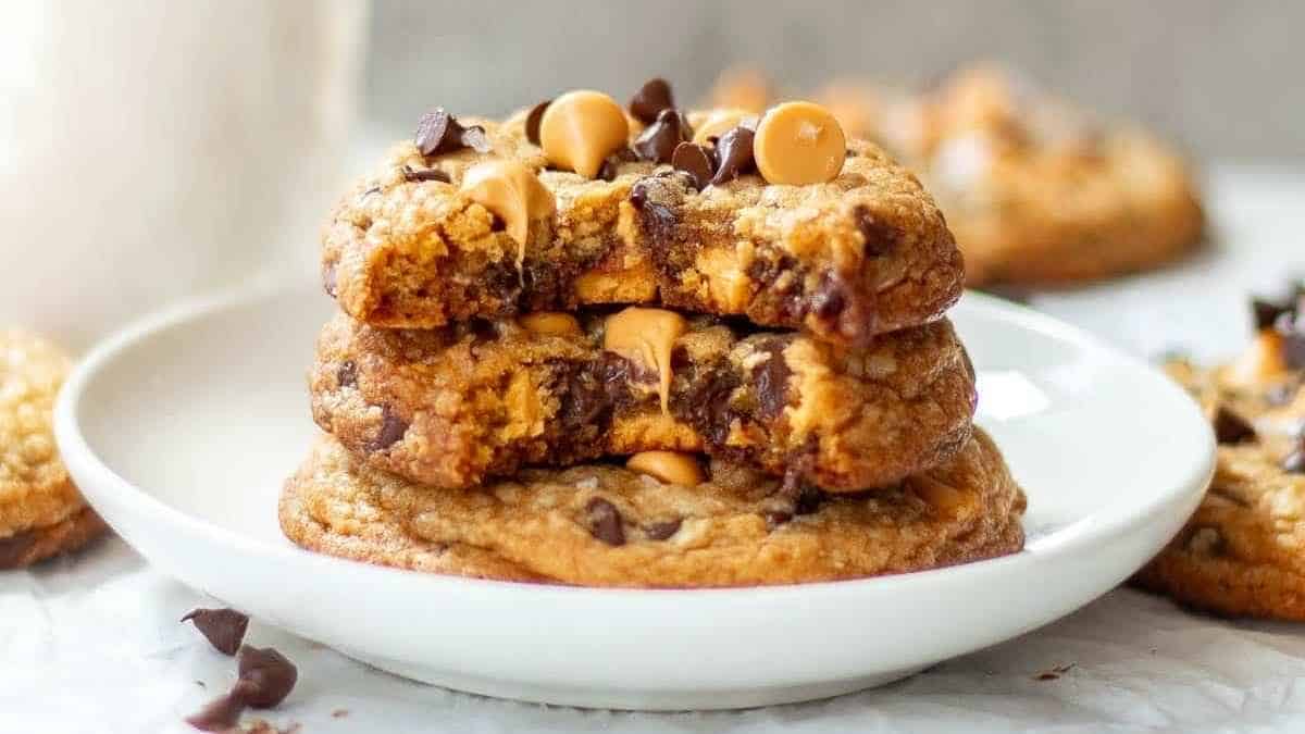 A stack of chocolate peanut butter cookies on a white plate.