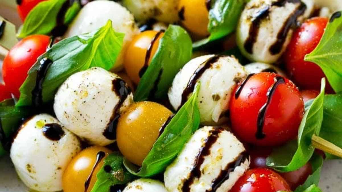 A colorful caprese salad with mozzarella, tomatoes, basil, and balsamic glaze.