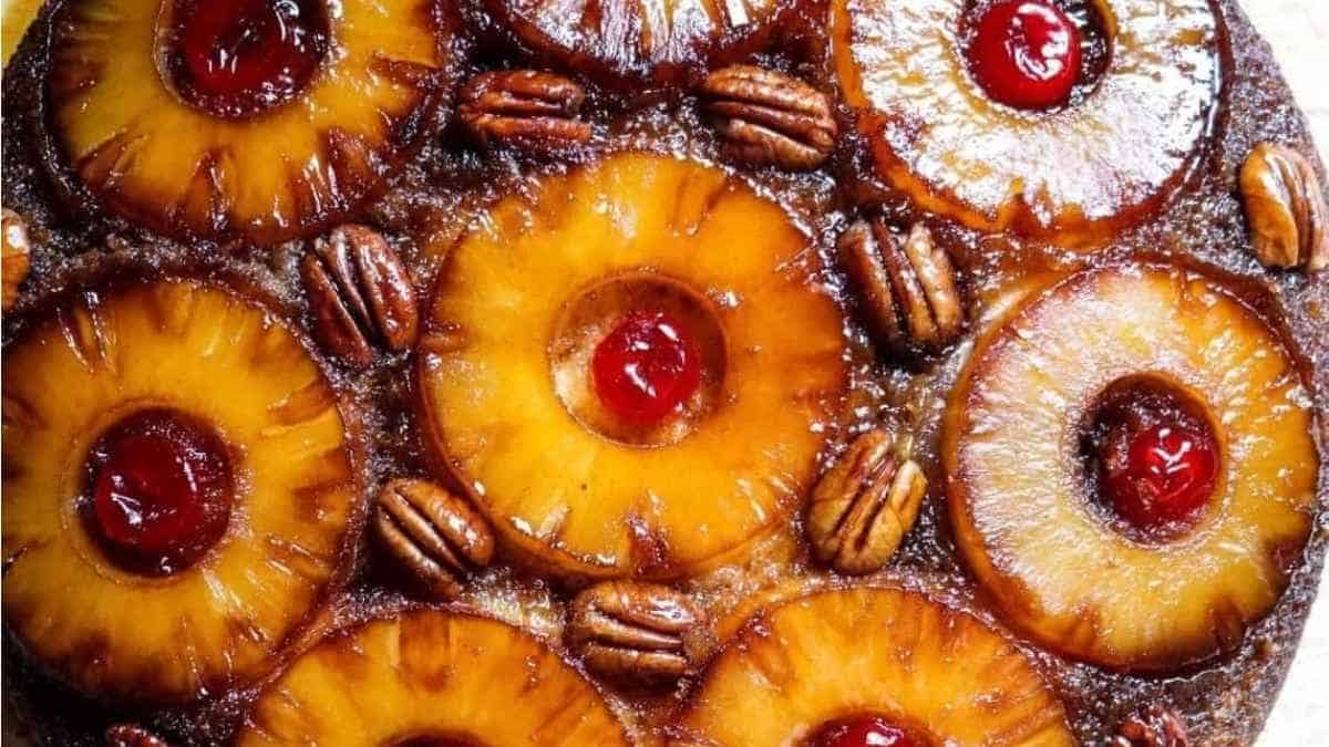 A pineapple upside down cake with cherries and pecans.