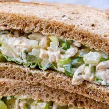 Chicken salad sandwich on whole grain bread with lettuce.