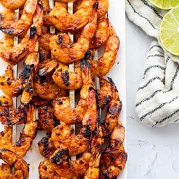 Try this keto-friendly dish of grilled shrimp skewers served with lime wedges.