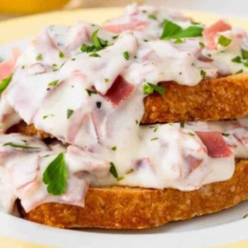 Ham and cheese toast on a plate with a fork.