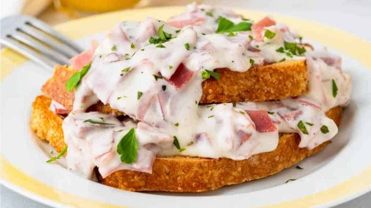 Ham and cheese toast on a plate with a fork.
