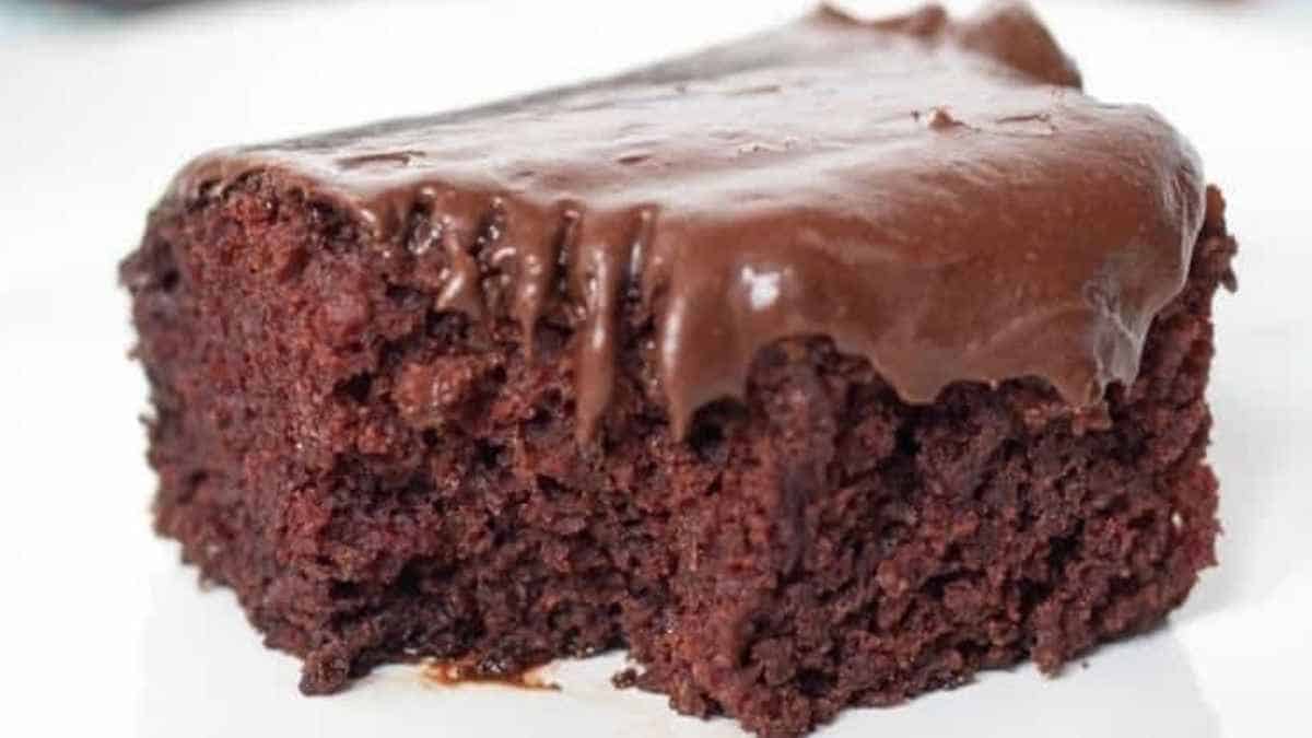 A piece of chocolate cake on a white plate.