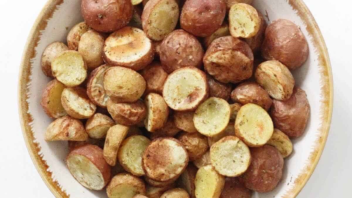 Roasted baby potatoes in a white dish.