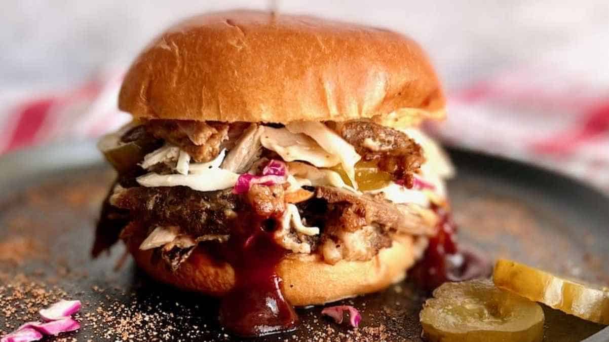 Bbq pulled pork sandwich with coleslaw and pickles on a brioche bun.