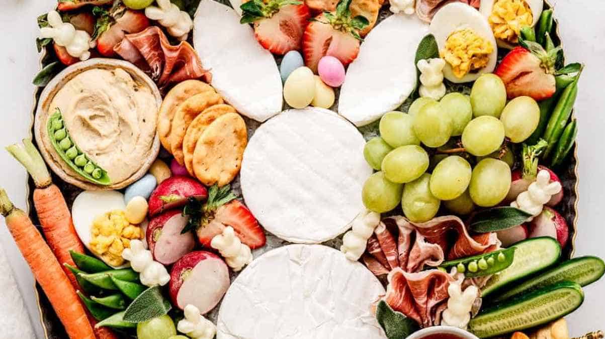 Assorted cheese and charcuterie board with fresh fruits, vegetables, and dips.