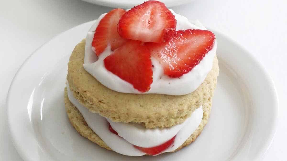 A strawberry shortcake with whipped cream and strawberries.