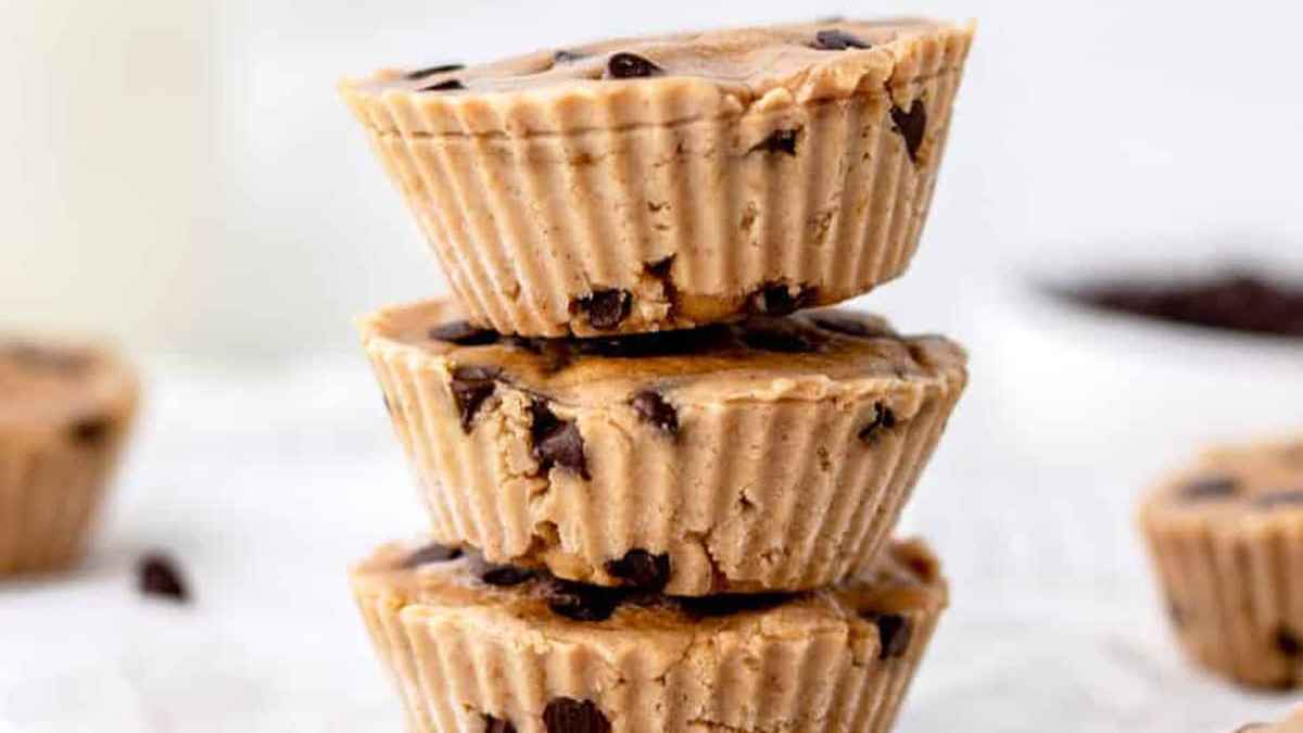 A stack of three peanut butter cups with chocolate chips on a white background.