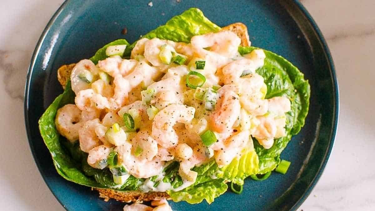 Shrimp salad on a blue plate.