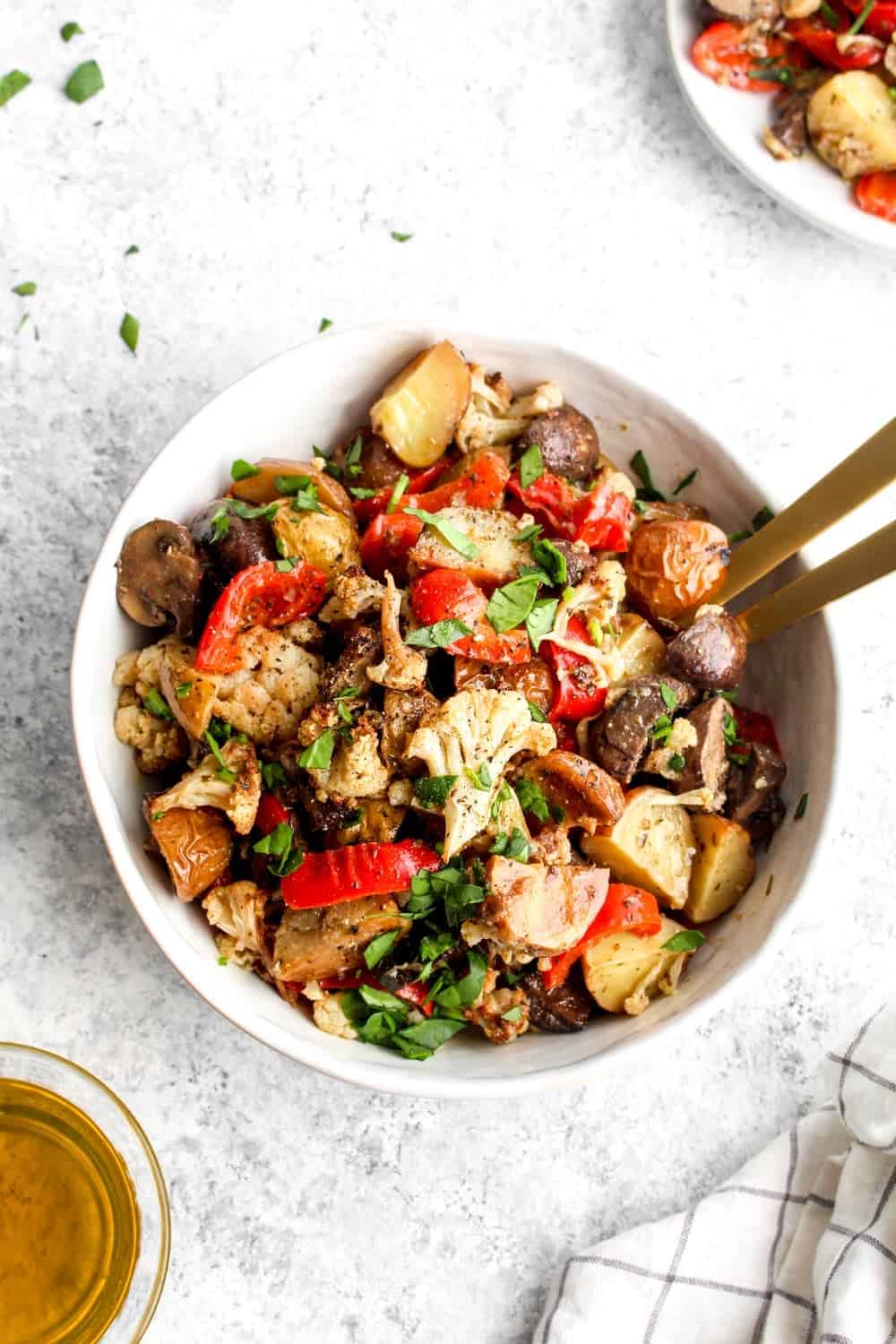 Marinated Vegetable Salad in a bowl with olive oil and herbs. 
