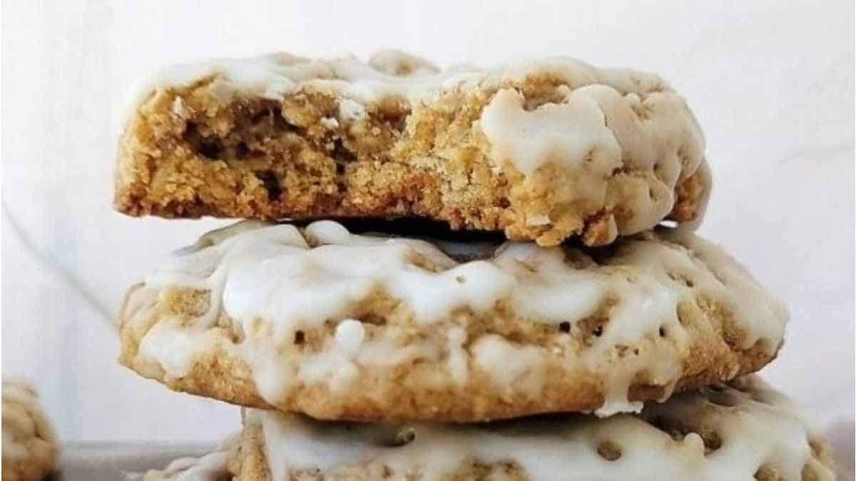 A stack of oatmeal cookies with icing on top.