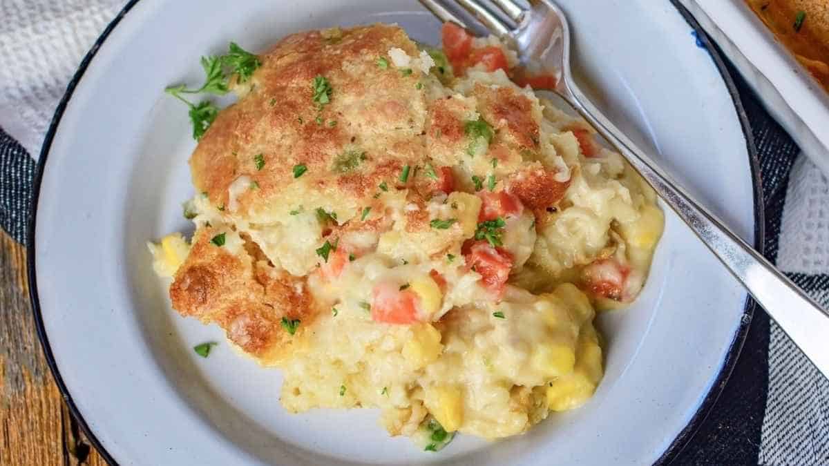 Cornbread casserole on a plate with a fork.