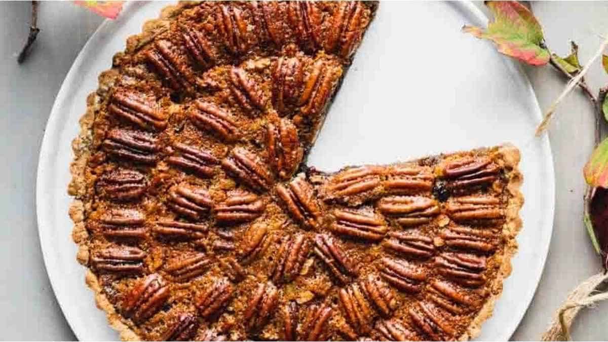 A pecan pie with a slice taken out.