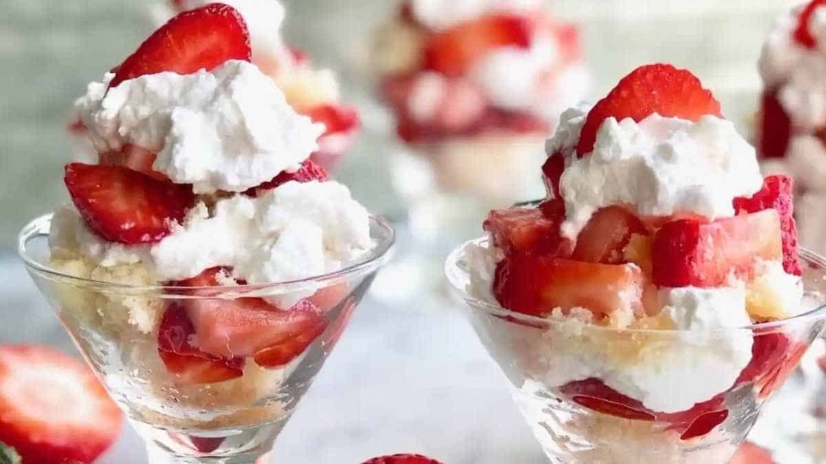 Strawberry shortcake in a glass with whipped cream and strawberries.