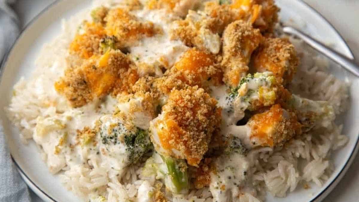 A plate of chicken and broccoli with rice on a plate.