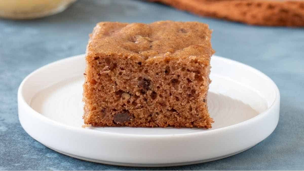 A slice of banana bread on a white plate.