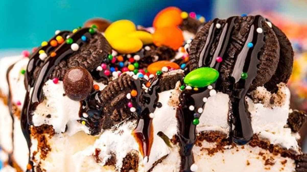 Colorful candy and cookies topping a creamy dessert.