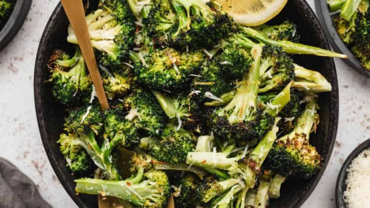 A bowl of broccoli with chopsticks.