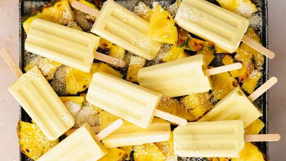 Grilled pineapple popsicles on a baking sheet.