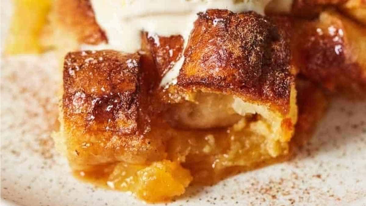 A close up of a piece of bread pudding with ice cream.