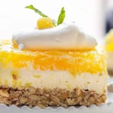 A slice of lemon cheesecake on a white plate.