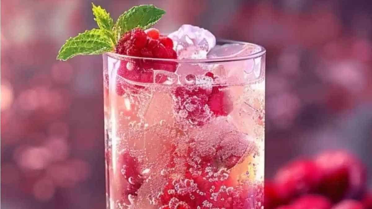 An iced drink with raspberries and mint.