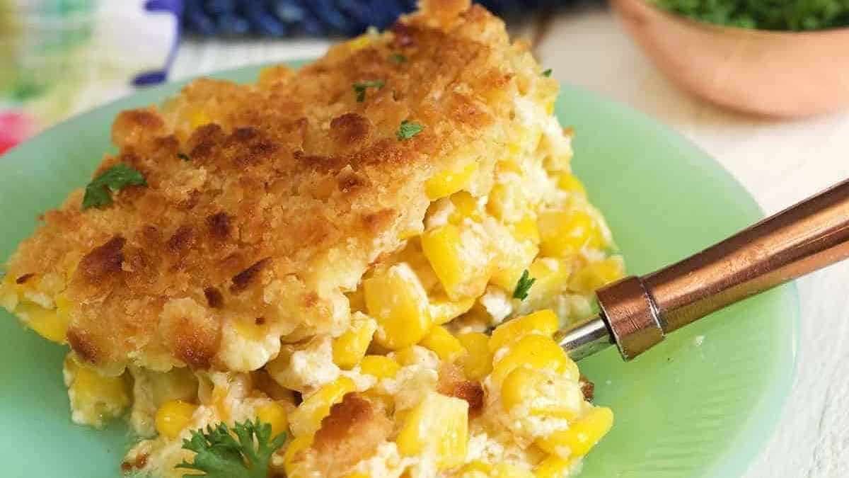 Corn casserole on a plate with a fork.