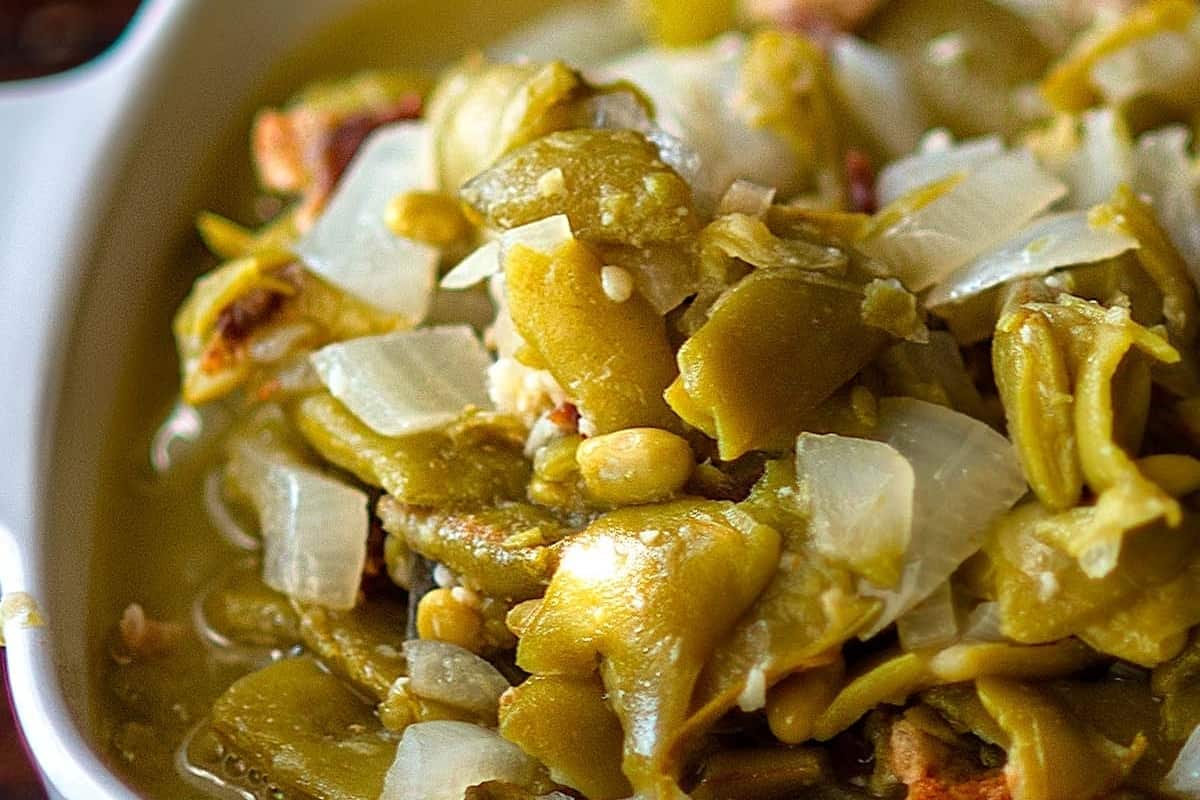 Close-up of a spicy green chili dish with onions.