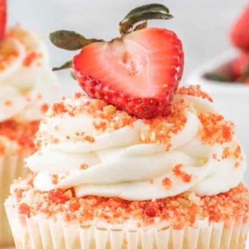 A cupcake with a strawberry on top.