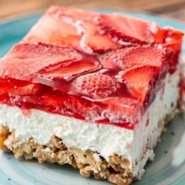A slice of strawberry cheesecake on a blue plate.