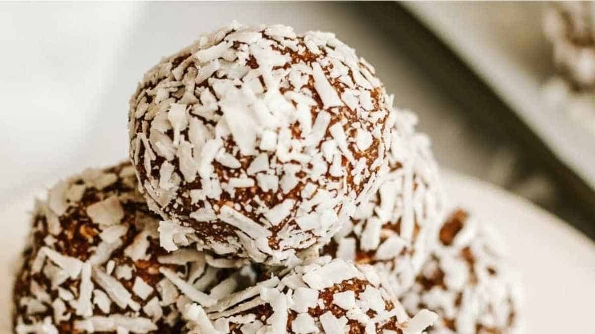 A stack of coconut energy balls on a plate.