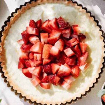 A pie with strawberries on top.