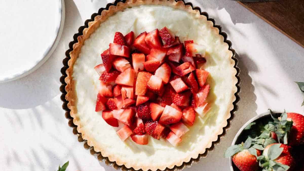 A pie with strawberries on top.