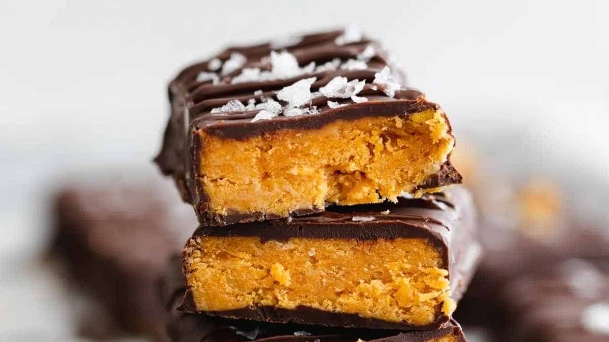 Chocolate peanut butter bars stacked on top of each other.