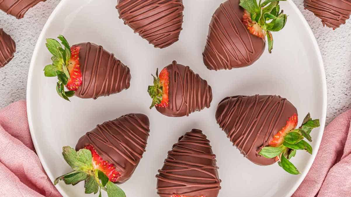 Chocolate covered strawberries on a plate.