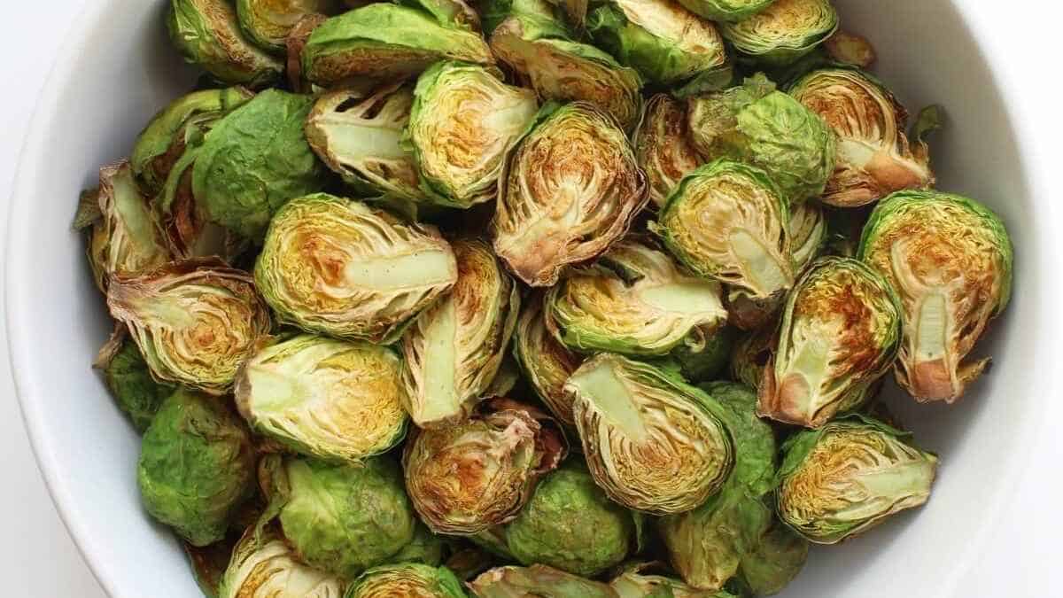 A bowl of halved, roasted brussels sprouts.