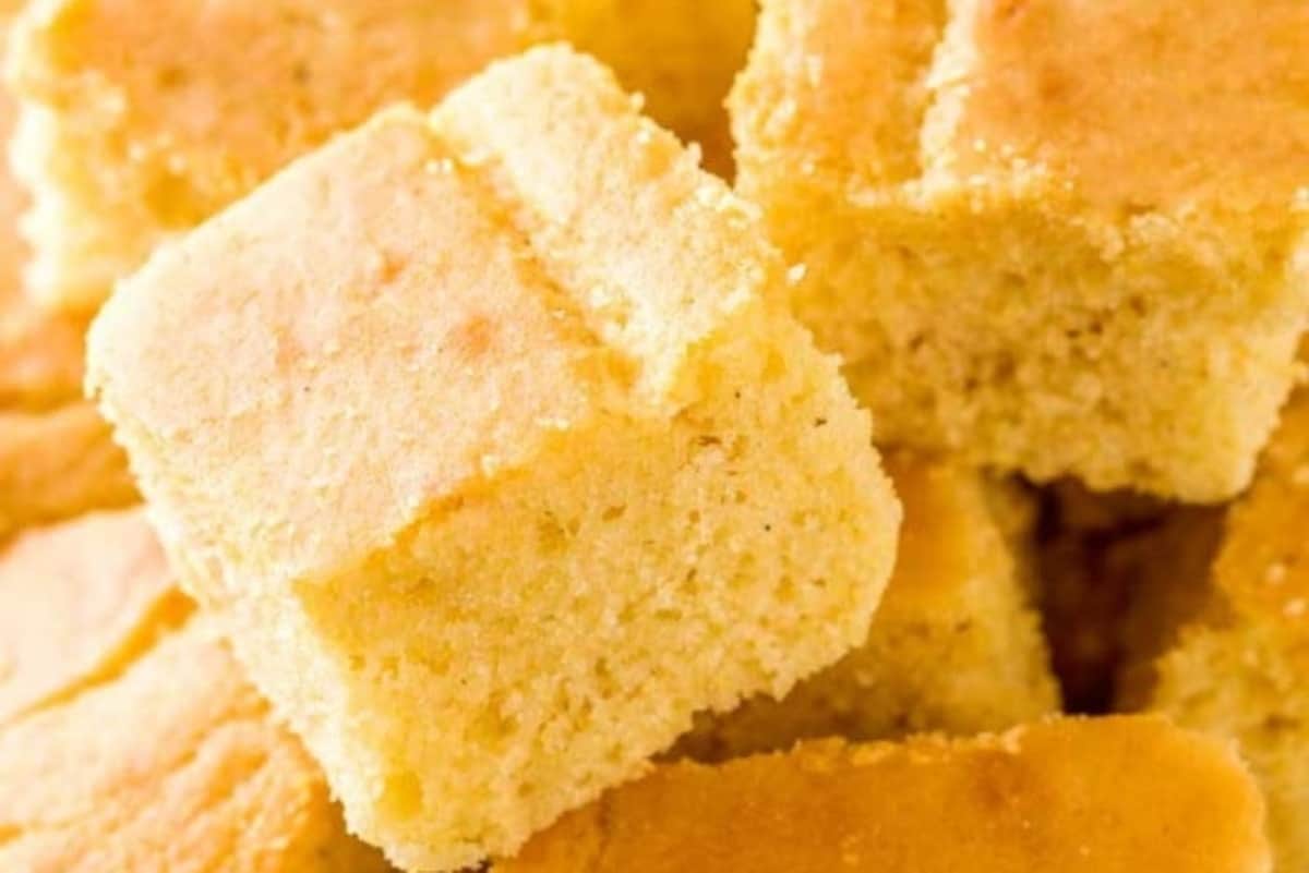 Close-up of golden brown squares of freshly baked cornbread.